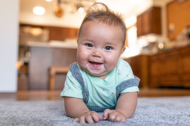 Baby laying on carpet flooring | Christian Brothers Flooring & Interiors